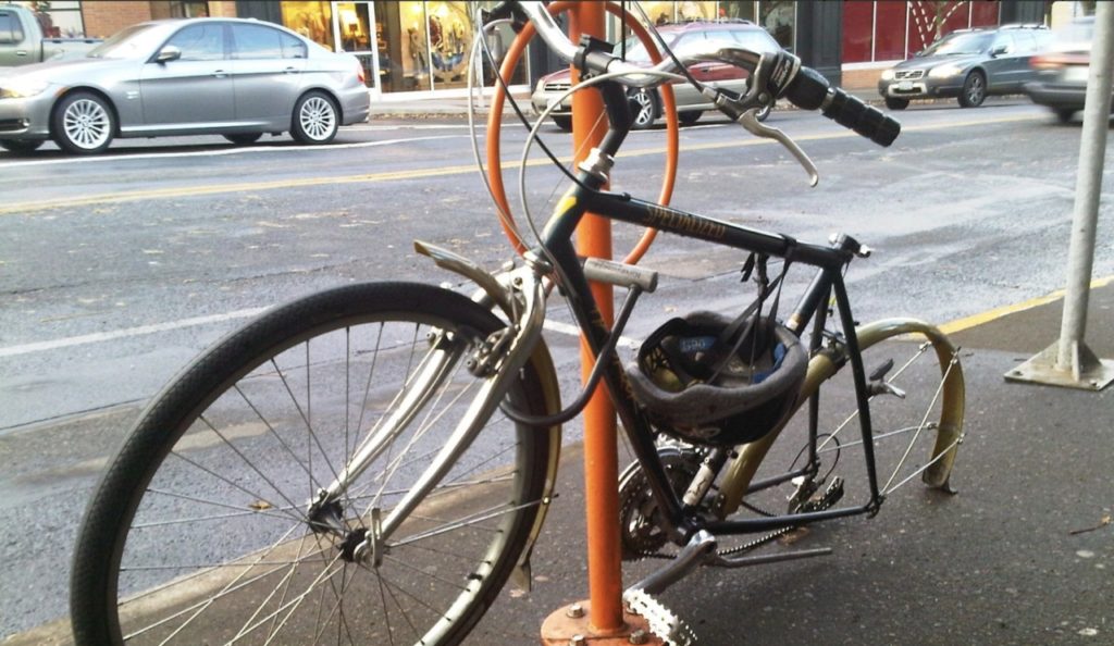 bike frame and front wheel locked to bike rack with rear wheel stolen