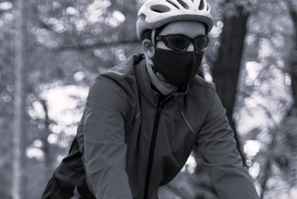 a bike rider outdoors wearing a face mask