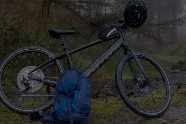 A bike and a backpack are placed on the roadside, indicating a pause during a journey or outdoor adventure.