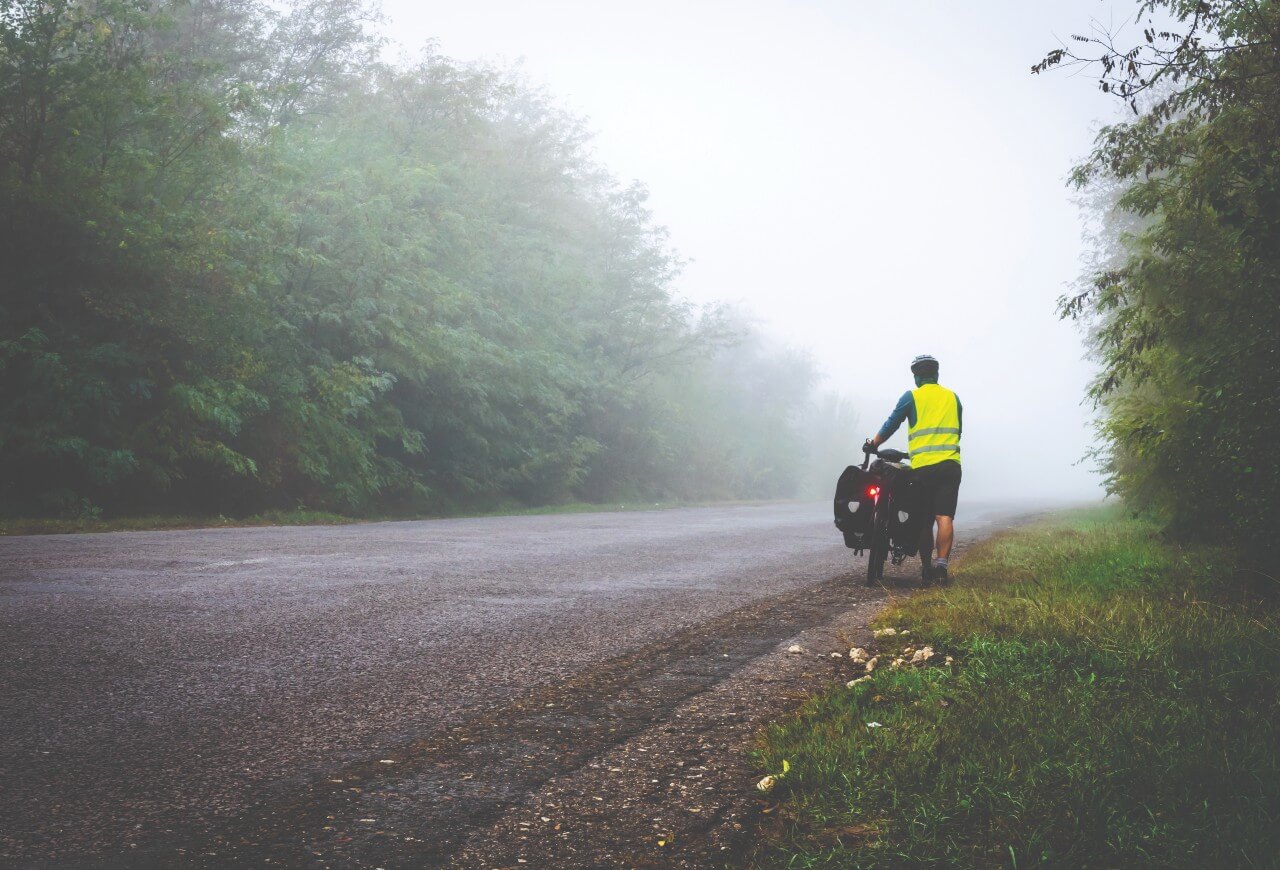 cyclist wearing a fluorescent vest with reflective materials